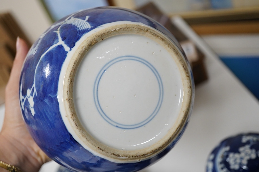 An 18th century Chinese blue and white dish, two jars (one without cover), a teapot and two carved wooden stands